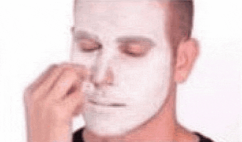 a man with a clown makeup on his face .