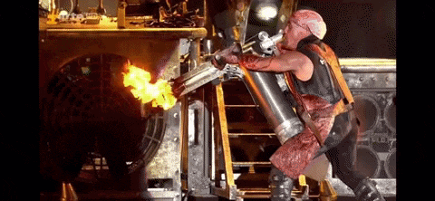 a man is holding a flamethrower in his hand while standing on a ladder .