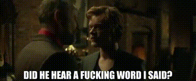 two men are standing next to each other and one of them is asking the other if he heard a fucking word he said .