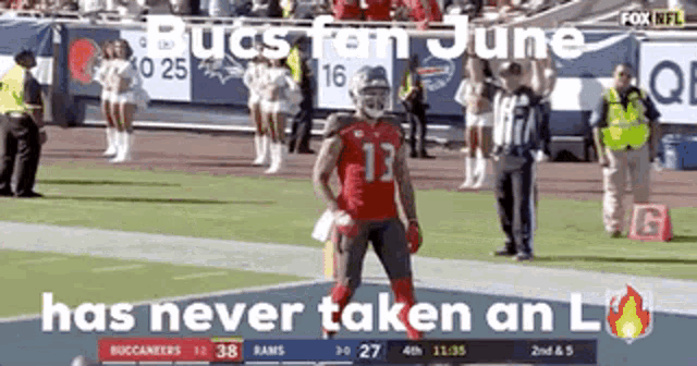 a football player with the number 13 on his jersey is standing on the field