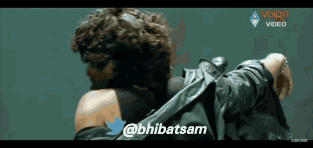 a man and a woman are hugging each other in a video that is sponsored by volga video