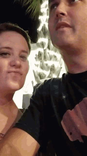 a man and a woman are standing next to each other