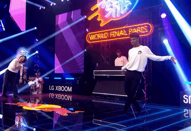 a man dancing on a stage with a sign that says world final paris