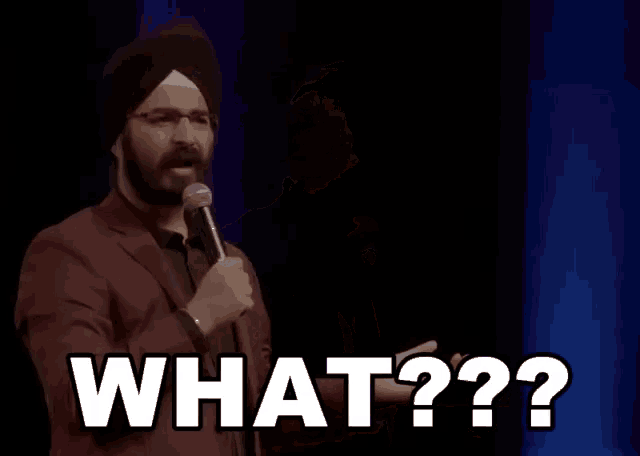 a man in a turban holds a microphone and says what??