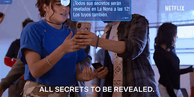 a man and a woman are looking at their cell phones with a netflix ad behind them