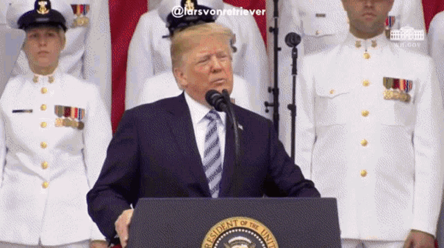donald trump stands behind a podium with the seal of the president of the united states in front of him