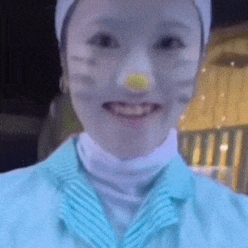a close up of a person 's face with a cat mask on .