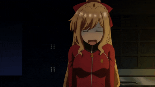 a girl in a red jacket is holding a small cup