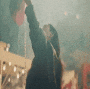 a woman is riding a swing at a carnival and holding a balloon .