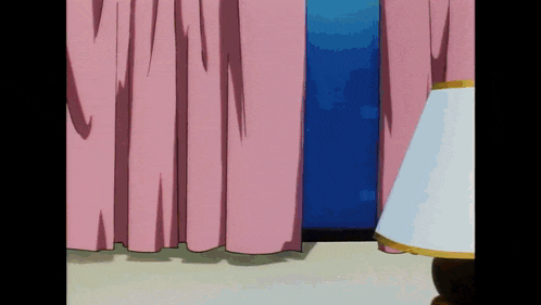 a lamp is sitting in front of a window with pink curtains