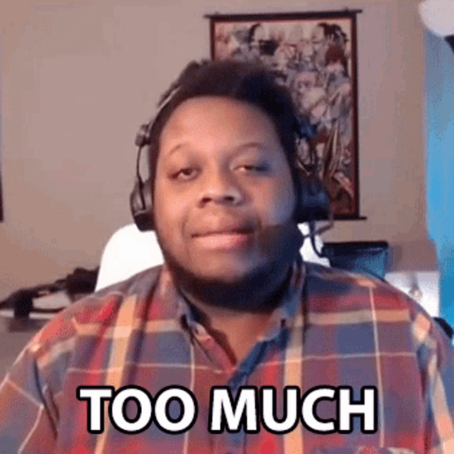 a man wearing headphones and a plaid shirt is saying too much .