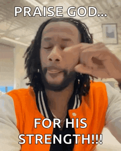 a man with dreadlocks is wearing an orange jacket and says praise god for his strength !!