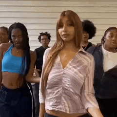 a group of young women are standing next to each other .