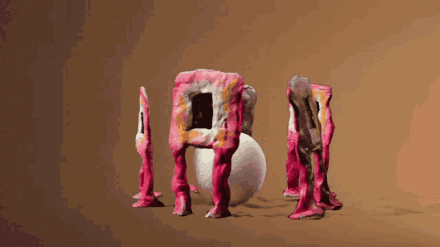 a group of pink sculptures are standing around an egg