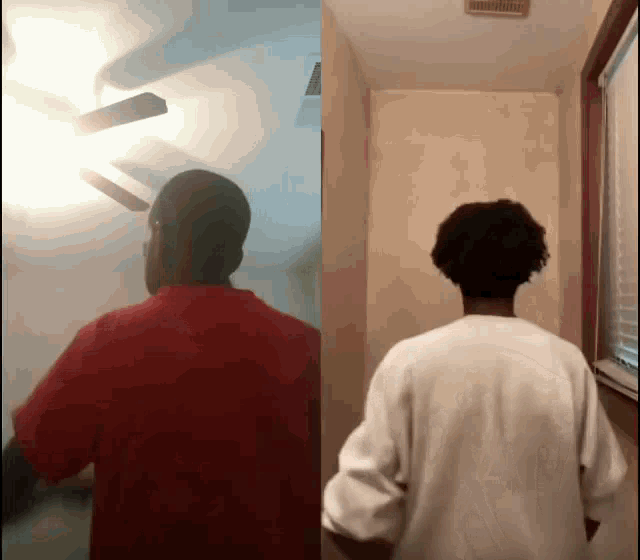 a man in a red shirt stands in front of a ceiling fan
