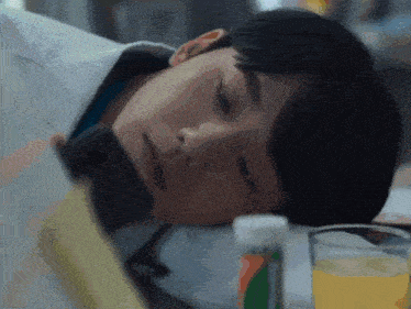a man is laying on a bed looking at his phone