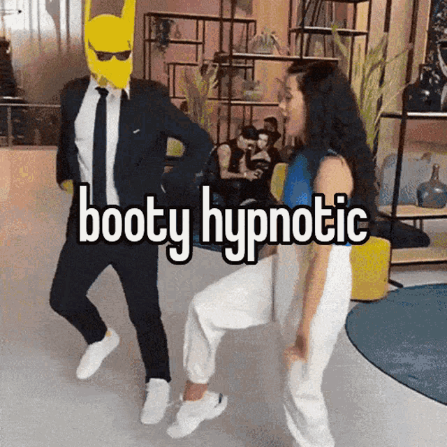 a man in a suit and tie is dancing with a woman in white pants and the words booty hypnotic behind him