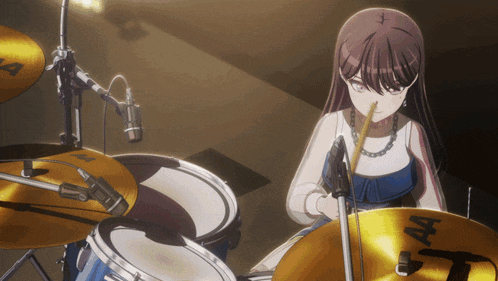 a girl is playing drums with a sabian cymbal in the foreground