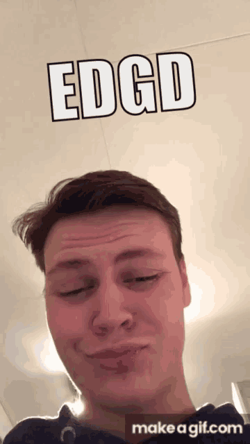 a man is making a funny face with the words edgd above him