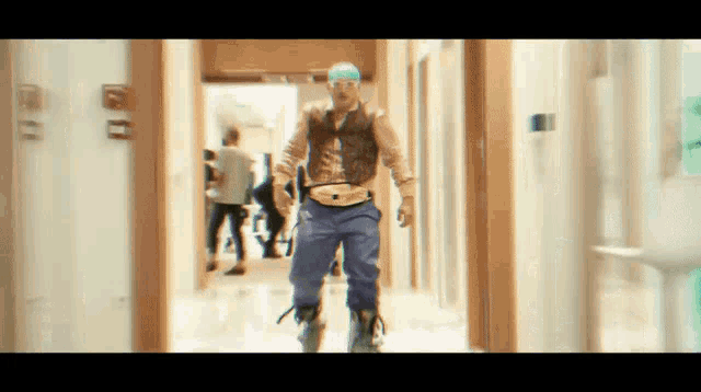 a blurry picture of a man walking down a hallway with a sign that says exit