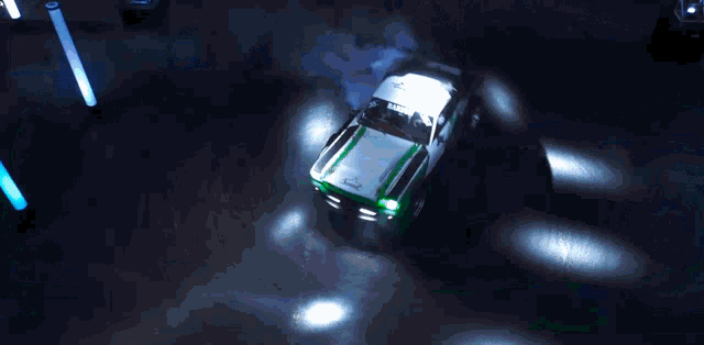 an aerial view of a green and white car with the letter t on it