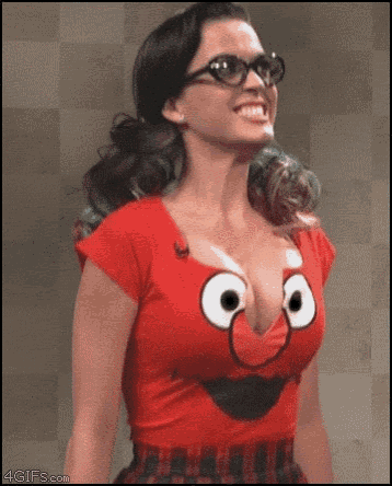a woman wearing glasses and a red shirt with a face on it .