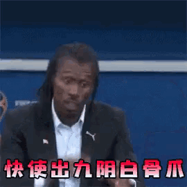 a man in a suit making a funny face with chinese writing on the bottom