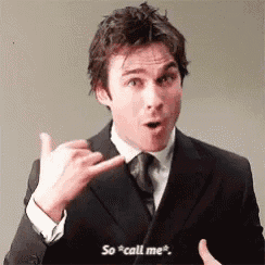 a man in a suit and tie is making a funny face and saying so call me .