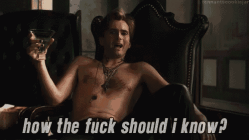 a shirtless man is sitting in a chair holding a martini glass and asking how the fuck should i know