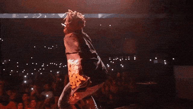juice wrld performs on stage in front of a crowd of people