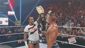 two men in a wrestling ring with a sign that says " i can 't come back "