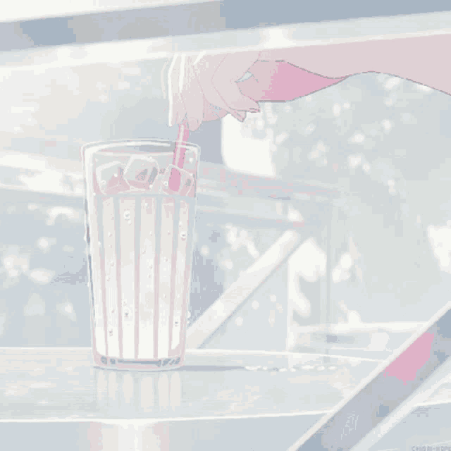 a hand is holding a pink straw in a glass with ice cubes