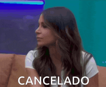 a woman is sitting on a couch with the word cancelado written on the bottom