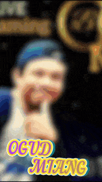 a blurry picture of a man with the words ogud milang on the bottom right