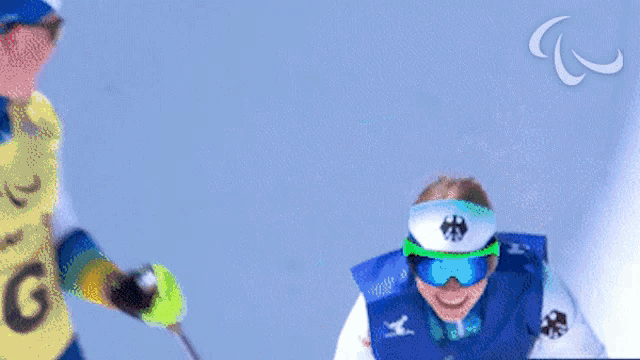 a person wearing a blue vest with a white emblem on the front
