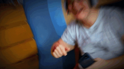 a blurry picture of a man holding a cellphone