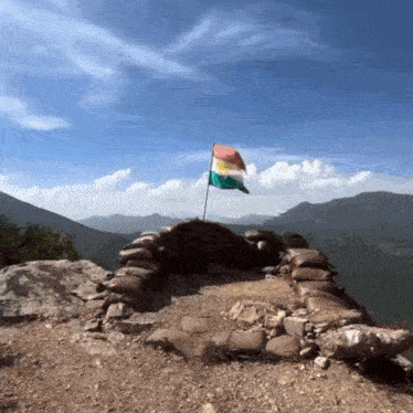 a flag is flying on top of a pile of sandbags