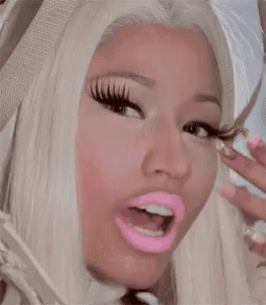 a close up of a woman 's face with blonde hair and pink lips .