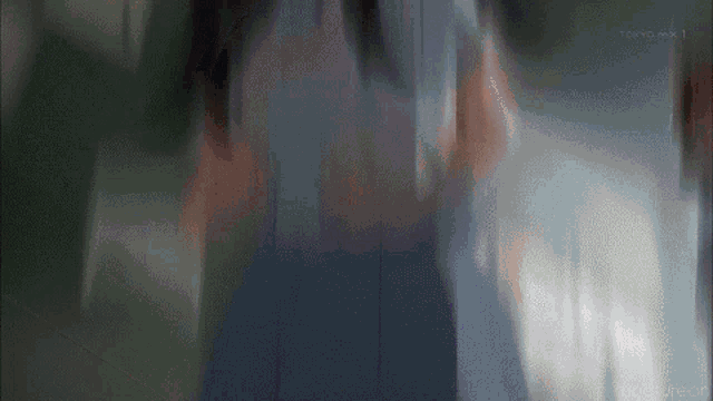 a blurry image of a person with tokyo mx 1 written on the bottom right