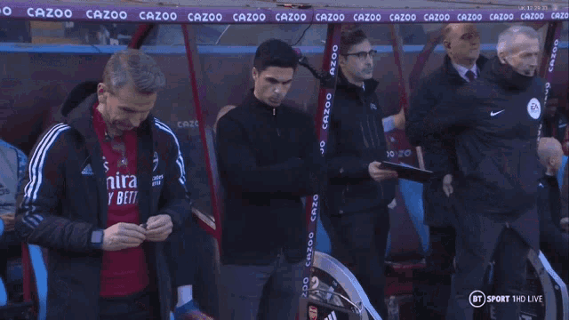 a man named mikel arteta is standing in a soccer stadium