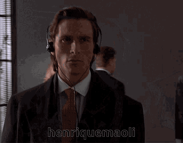 a man wearing headphones with the name henriquemaoli written on the bottom