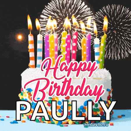 a birthday cake with candles and fireworks and the name paully on it .