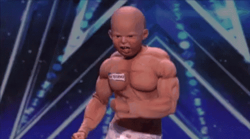 a baby doll with muscles and a tag on his chest that says 1018943