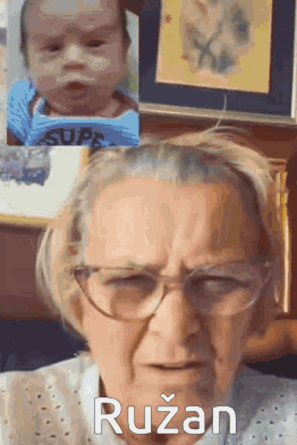 an elderly woman wearing glasses is talking to a baby and the baby is wearing a shirt that says super