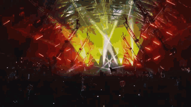 a crowd of people are watching a concert with a lot of lights