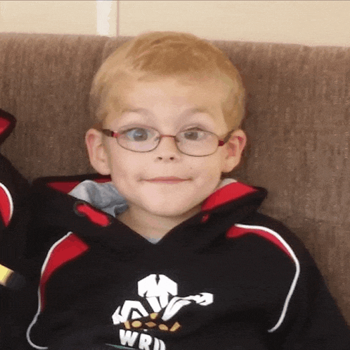 a young boy wearing glasses and a sweatshirt that says wrd