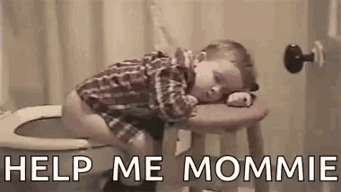 a little boy is sleeping on a stool next to a toilet .