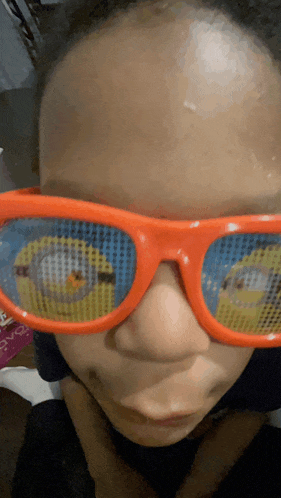 a close up of a person wearing sunglasses with a picture of a cartoon character on them