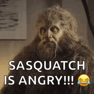 a sasquatch with a beard is angry and laughing .