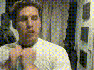 a man in a white shirt is tying a bow tie .